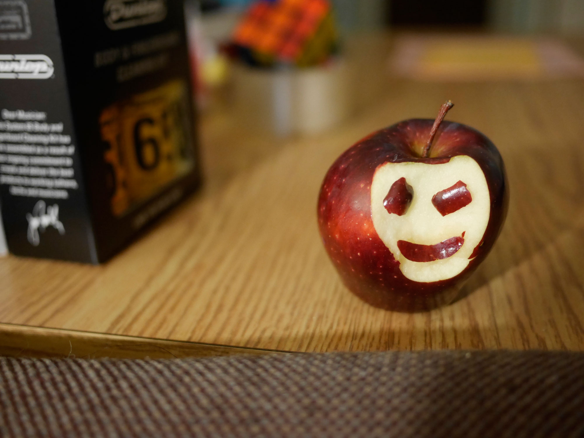 Photo of an apple with a smiley face.